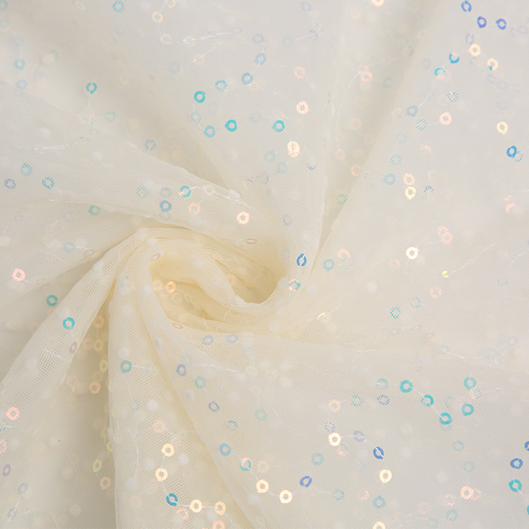 Ivory tulle scattered with iridescent sequins, swirled